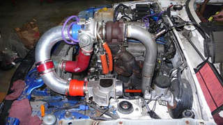 Illustration for article titled Eyesore Racing's Ghettocharged Miata Fears No Turbocharged Peugeot Surrender Monkeys!